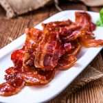 Bacon on White Plate with Herbs